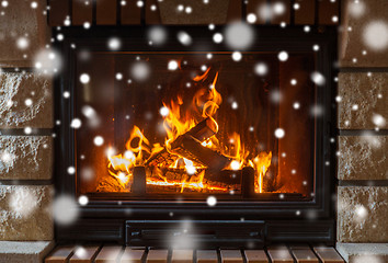 Image showing close up of burning fireplace with snow