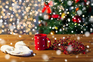 Image showing tea cup with mittens and christmas decoration