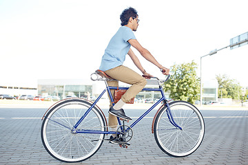 Image showing young hipster man riding fixed gear bike