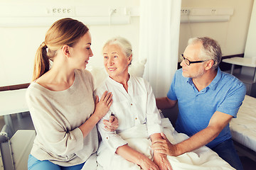 Image showing happy family visiting senior woman at hospital