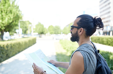 Image showing close up of man with backpack and map in city