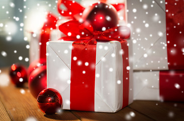 Image showing close up of gift boxes and red christmas balls