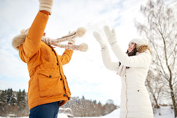 Image showing happy couple playing with snow in winter