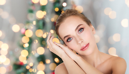 Image showing beautiful woman face over christmas lights