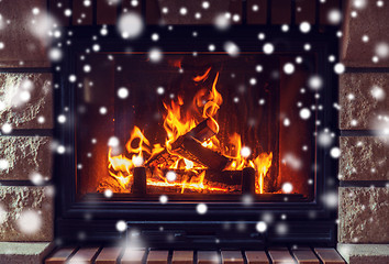 Image showing close up of burning fireplace with snow