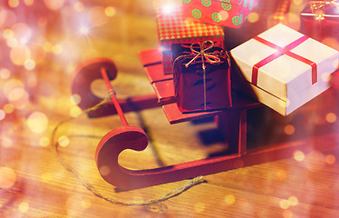 Image showing close up of christmas gift boxes on wooden sleigh