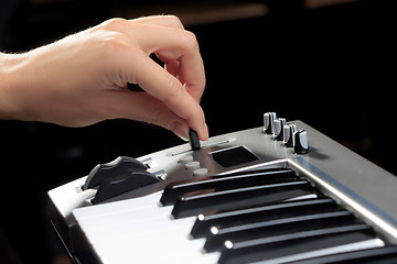 Image showing Girl\'s hands on the keyboard of the piano