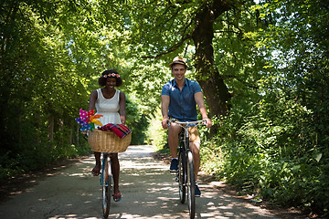 Image showing Young multiethnic couple having a bike ride in nature