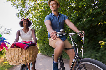 Image showing Young multiethnic couple having a bike ride in nature