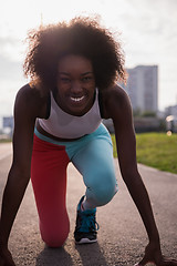 Image showing Portrait of sporty young african american woman running outdoors