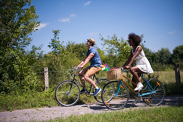 Image showing Young multiethnic couple having a bike ride in nature