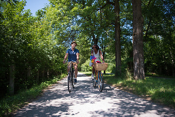 Image showing Young multiethnic couple having a bike ride in nature