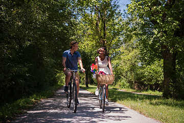 Image showing Young multiethnic couple having a bike ride in nature