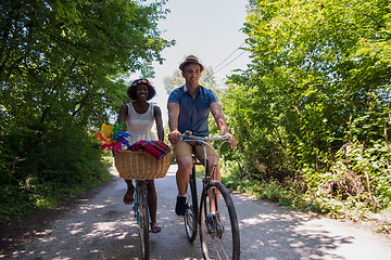 Image showing Young multiethnic couple having a bike ride in nature