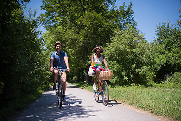 Image showing Young multiethnic couple having a bike ride in nature