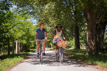 Image showing Young multiethnic couple having a bike ride in nature