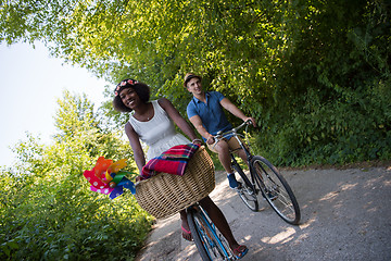 Image showing Young multiethnic couple having a bike ride in nature