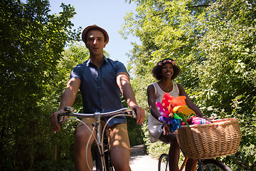 Image showing Young multiethnic couple having a bike ride in nature