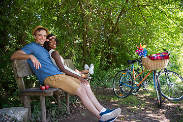 Image showing Young multiethnic couple having a bike ride in nature