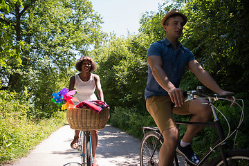 Image showing Young multiethnic couple having a bike ride in nature