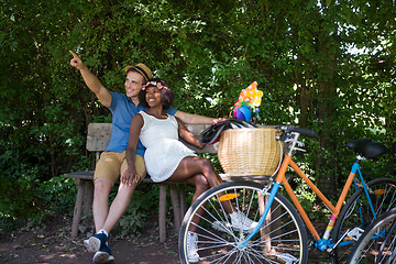 Image showing Young multiethnic couple having a bike ride in nature