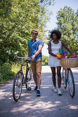 Image showing Young multiethnic couple having a bike ride in nature