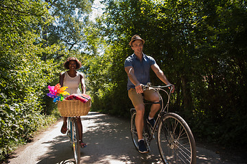 Image showing Young multiethnic couple having a bike ride in nature