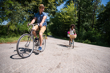 Image showing Young multiethnic couple having a bike ride in nature