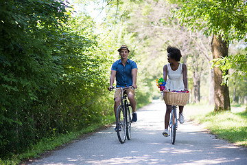 Image showing Young multiethnic couple having a bike ride in nature