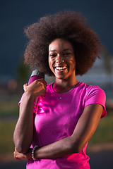 Image showing Portrait of a young african american woman running outdoors