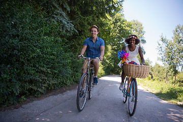 Image showing Young multiethnic couple having a bike ride in nature