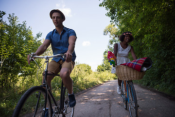 Image showing Young multiethnic couple having a bike ride in nature