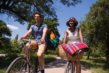 Image showing Young multiethnic couple having a bike ride in nature