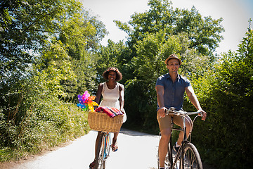 Image showing Young multiethnic couple having a bike ride in nature