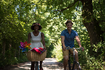 Image showing Young multiethnic couple having a bike ride in nature