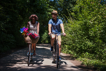 Image showing Young multiethnic couple having a bike ride in nature