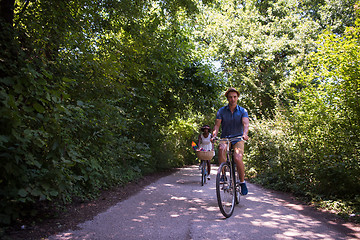 Image showing Young multiethnic couple having a bike ride in nature