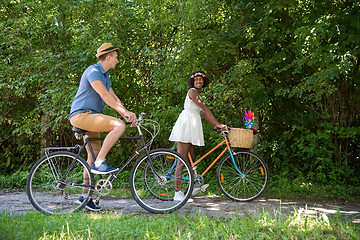 Image showing Young multiethnic couple having a bike ride in nature