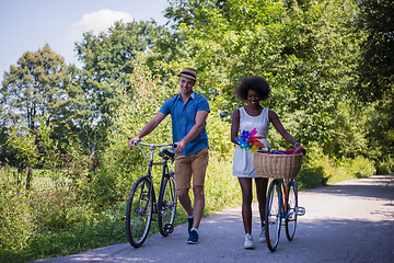 Image showing Young multiethnic couple having a bike ride in nature