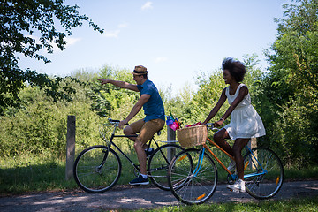 Image showing Young multiethnic couple having a bike ride in nature