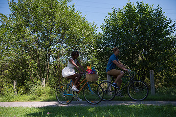 Image showing Young multiethnic couple having a bike ride in nature