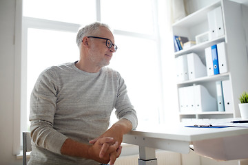 Image showing senior man sitting at medical office table