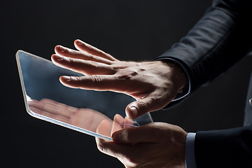 Image showing close up of businessman with transparent tablet pc