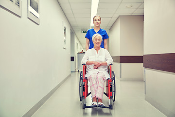 Image showing nurse with senior woman in wheelchair at hospital