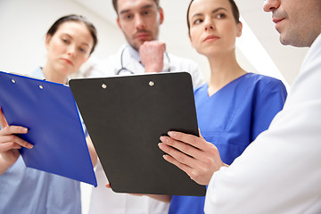 Image showing close up of doctors with clipboard at hospital