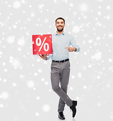 Image showing smiling man with red percentage sign over snow