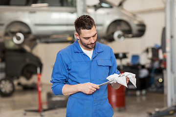 Image showing auto mechanic or smith with wrench at car workshop