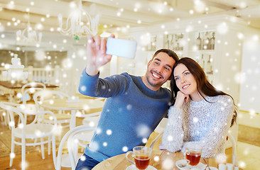 Image showing couple taking smartphone selfie at cafe restaurant