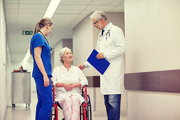 Image showing medics and senior woman in wheelchair at hospital