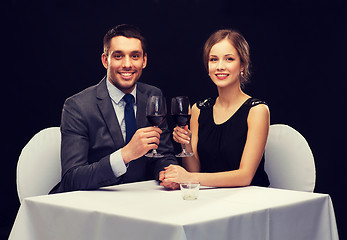 Image showing young couple with glasses of wine at restaurant